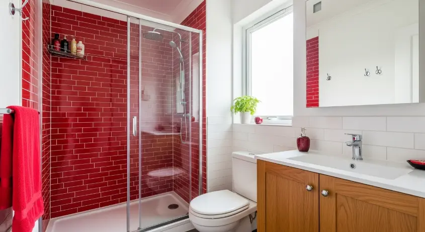 cherry red bathroom with a red tiled shower